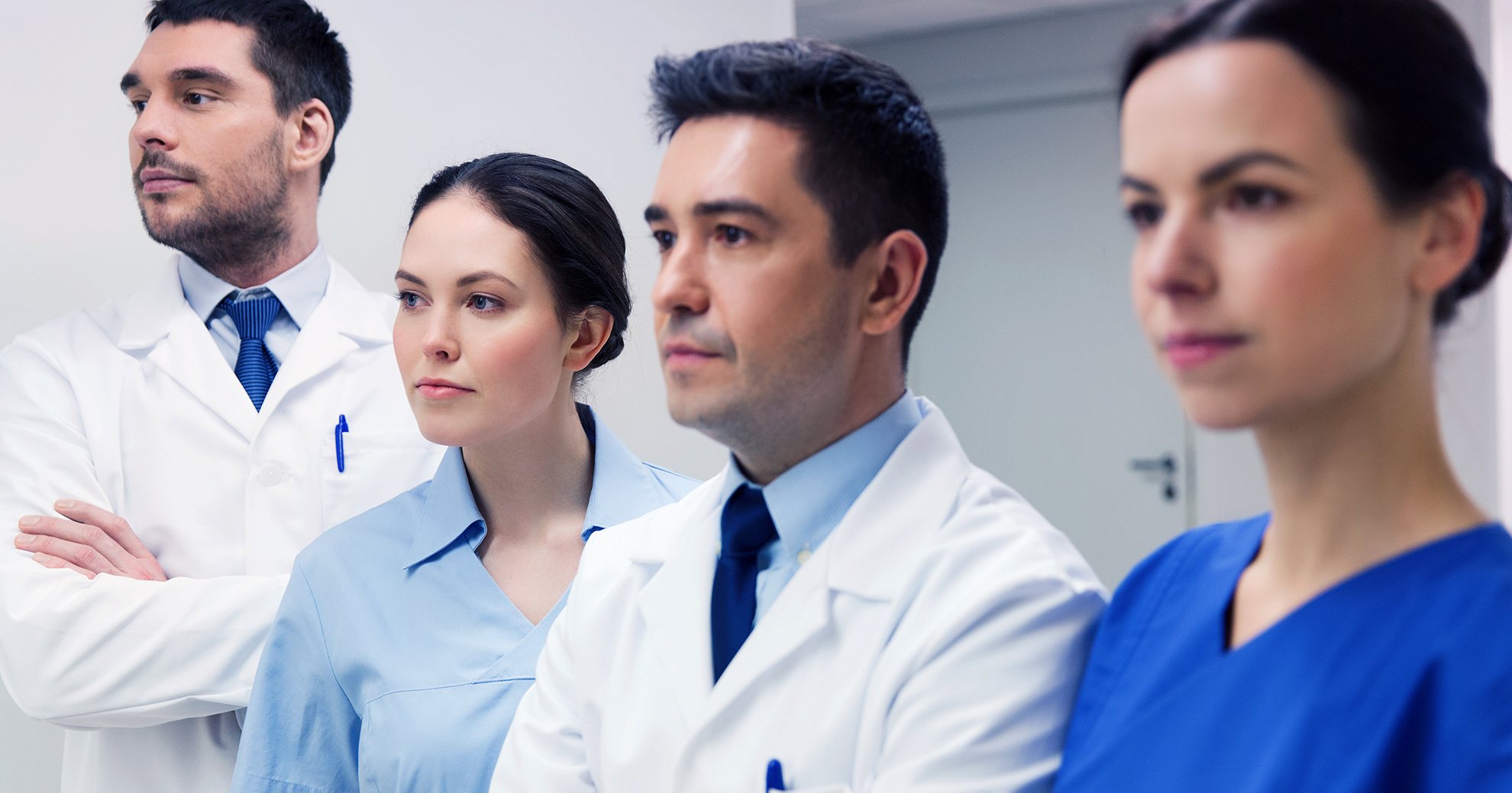 clinic, profession, people, health care and medicine concept - group of medics or doctors at hospital corridor